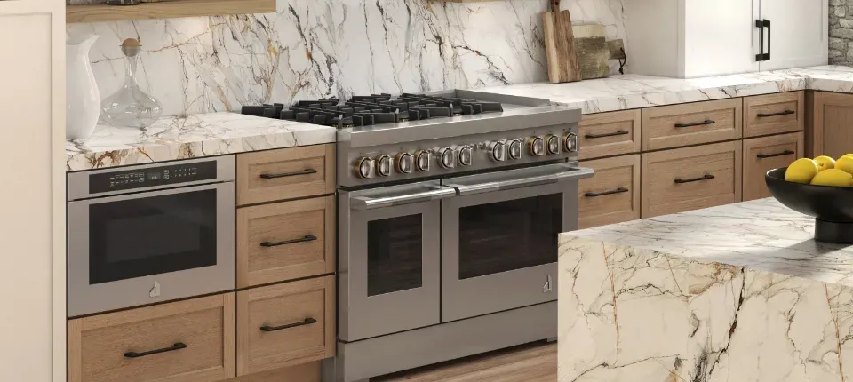 stainless steel duel fuel range stove in between marble counters